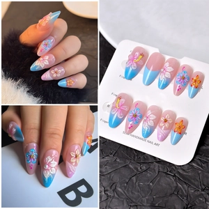 Detail of 3D embossed floral nail art with almond shape and blue-pink gradient