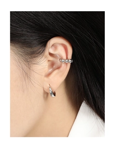 Detailed view of S925 sterling silver ear cuffs with small crystals on a model's ear