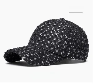 Detailed close-up of a black sequins baseball cap featuring trendy distressed ripped denim
