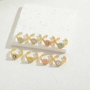 Detail view of 8 gold evil eye rings with colorful enamel and sparkling zircons