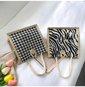 Detail showing houndstooth and zebra pattern canvas tote bags with wooden button closures