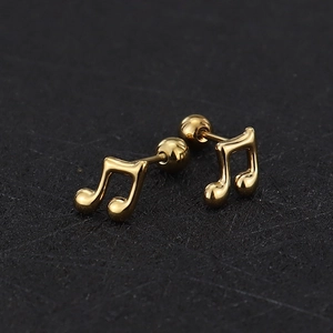Macro shot of gold musical note stud earrings with secure ball screw back closure