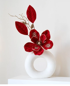 Detail of red velvet Christmas flower with sequins in a white ceramic vase decoration