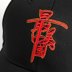 Close-up of high-density 3D embroidery showing red and gold Chinese character on black cap