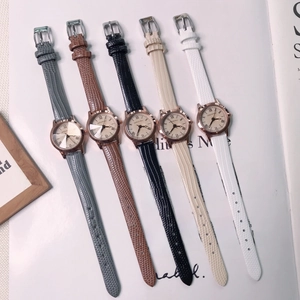 Close-up of five colorful leather strap watches displayed on a magazine page