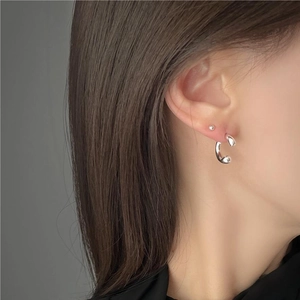Close-up of minimalist S925 sterling silver ball stud and U-shaped hoop earring set