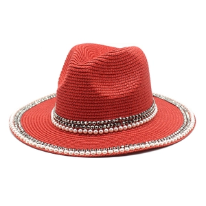 Red wide brim straw fedora hat with white faux pearls and dark grey rhinestone band