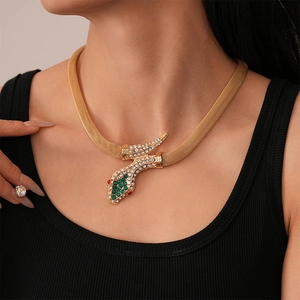 Close-up of golden mesh snake necklace with sparkling rhinestones on female model