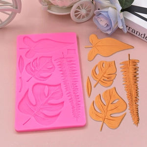 Pink silicone mold featuring various tropical leaf patterns for DIY cake decoration