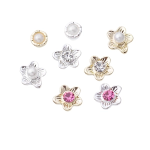 DIY floral nail art charms with pearls and rhinestones in gold and silver settings