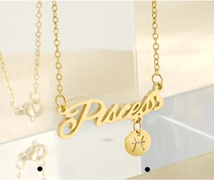 Macro shot of 18k gold plated stainless steel Pisces zodiac necklace with engraving