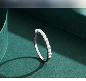 Detail of elegant 925 silver ring featuring eleven small white pearls in a row