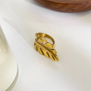 Macro close-up of 18k gold plated stainless steel leaf ring on a clean white surface