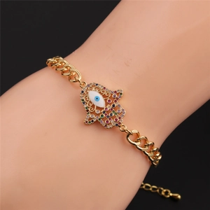 Detailed close-up of gold-plated Hamsa Hand bracelet with colorful zircon stones on wrist