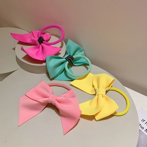 Macro shot of colorful air cotton bow hair ties featuring handmade woven ribbon detail
