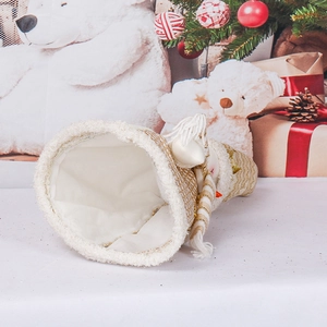 Creative white and gold knit Christmas tree ornament with sequins on a festive tabletop