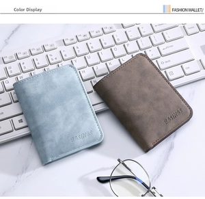 Macro detail of slim bifold wallets in light blue and brown on a minimalist marble desk