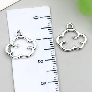 Detailed view of two silver cloud charms with ruler showing 1.5cm width dimension
