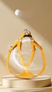 Close-up of ginger yellow suede dog harness with sturdy metal D-rings and buckle