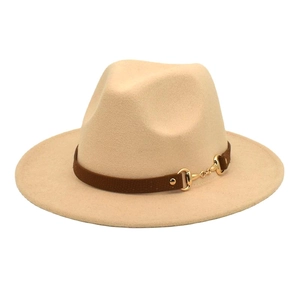 Detail of beige wool fedora featuring a brown suede band and golden horsebit buckle
