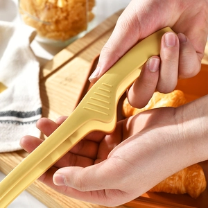 Handheld yellow silicone kitchen food tongs for BBQ and baking with non-slip texture