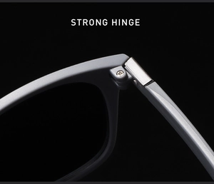 Detail of durable metal hinge and screw assembly on matte gray sports sunglasses