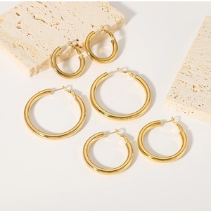 Detailed set of three polished 18K gold plated hollow hoop earrings in varying sizes