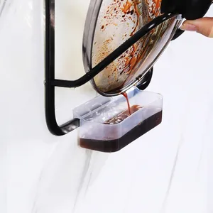 Wall-mounted black matte pot lid rack with a removable transparent water drip tray