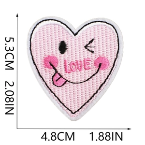 Detail of pink embroidered heart patch with LOVE text and winking emoji, 5.3x4.8cm size