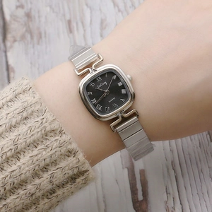 Elegant women's square quartz watch with silver bamboo link mesh strap on a model's wrist