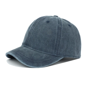 Detailed close-up of a vintage navy blue washed cotton baseball cap with retro texture