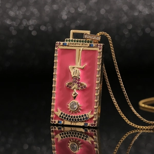 Macro shot of rectangular pink enamel pendant with colorful zircon stones and gold relief