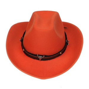 Detail of orange wool cowboy hat featuring silver bull head metal ornament and braided band