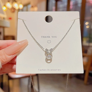 Detailed view of rabbit ear pendant with dancing cubic zirconia on silver chain