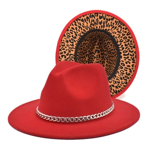 Detail of red fedora hat with silver chain and stylish leopard print lining on the brim