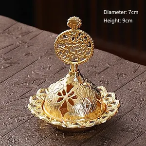 Detail shot of golden metal incense burner with hollow carvings, 7cm wide and 9cm high