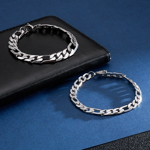 Minimalist silver Figaro chain bracelets in stainless steel on black leather background