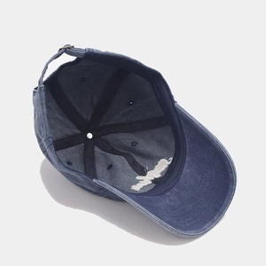 Detail of blue cotton baseball cap interior structure with metal buckle and stitching