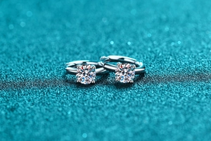 Macro view of 925 sterling silver hoop earrings with four-prong moissanite setting