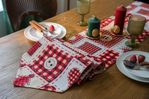 Detail of Christmas plaid table runner with vintage buttons and decorative stitching
