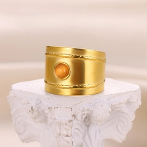 Detail of wide gold-plated ring featuring double rope texture and orange cat eye gemstone