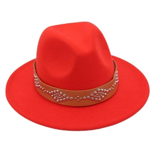 Detail of red wool felt fedora featuring a brown leather band with silver studded rivets