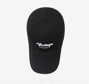 Top view of black cotton baseball cap with white Vintage YOURSELF embroidery detail