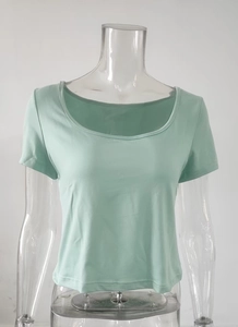 Detail of light green slim fit t-shirt featuring square neckline and ribbed knit texture