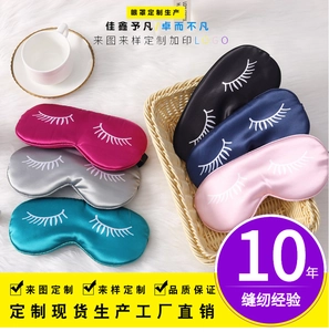 Macro detail of silk satin sleep masks with eyelash embroidery in five various colors