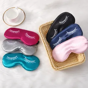 Macro detail of silk satin sleep masks with eyelash embroidery in five various colors