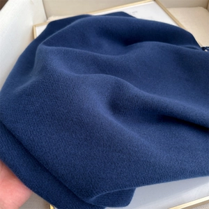 Macro view showing the soft texture of the blue cashmere-feel winter scarf fabric