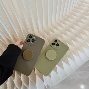 Detail of iPhone case with built-in circular kickstand in army green and light green