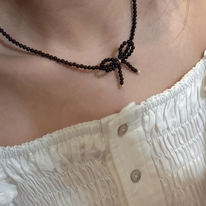 Elegant S925 sterling silver bow necklace with dark beaded chain on female neck