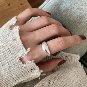 Close-up of minimalist adjustable 925 sterling silver ring worn on model's finger